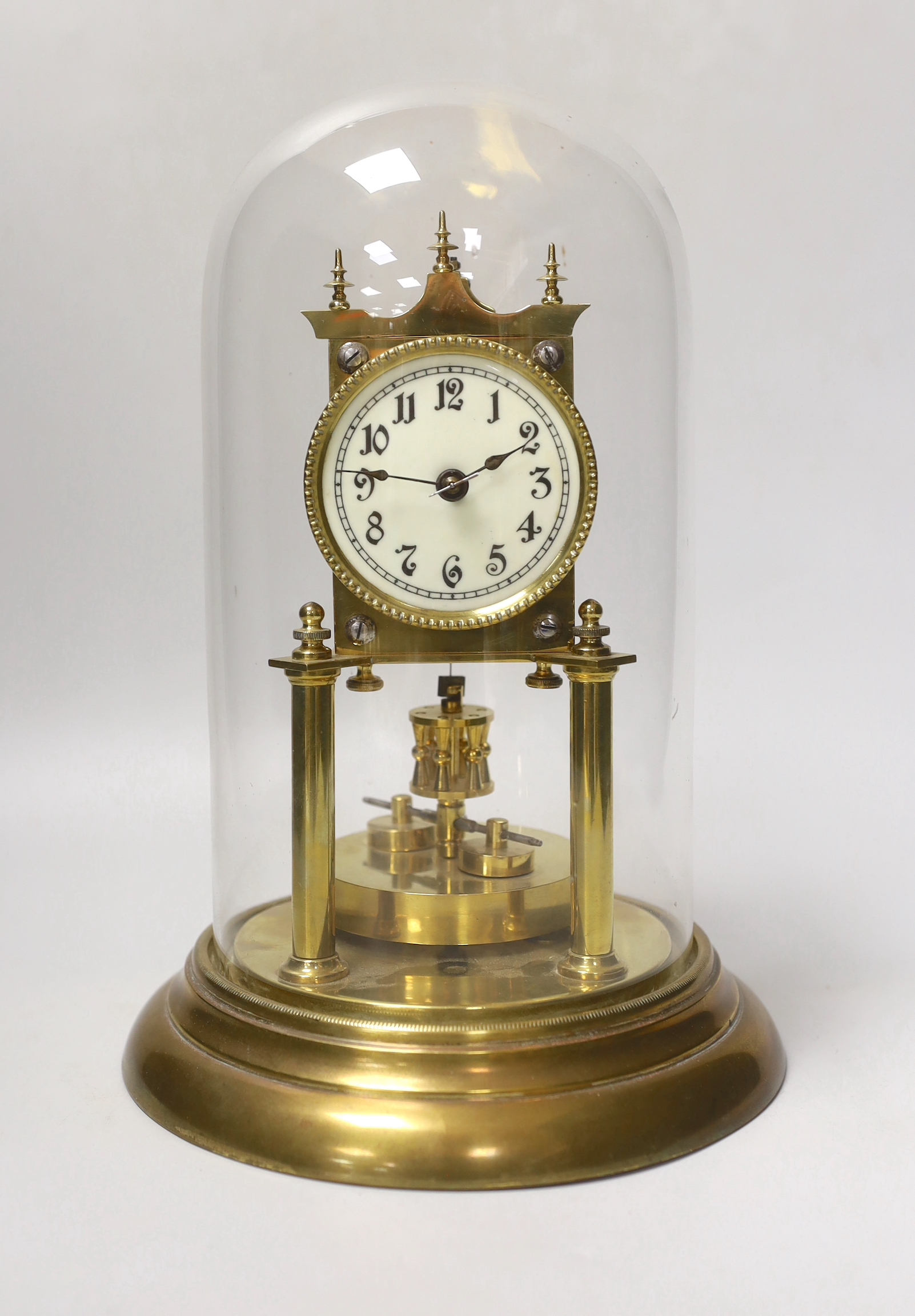 An early 20th century clock under glass dome, 29cm